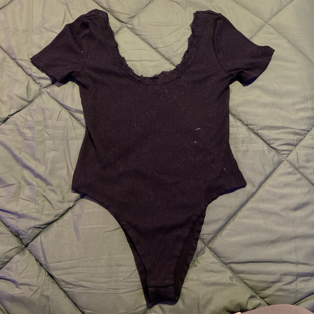 Black body suit with lace detailing on the neckline and short sleeves